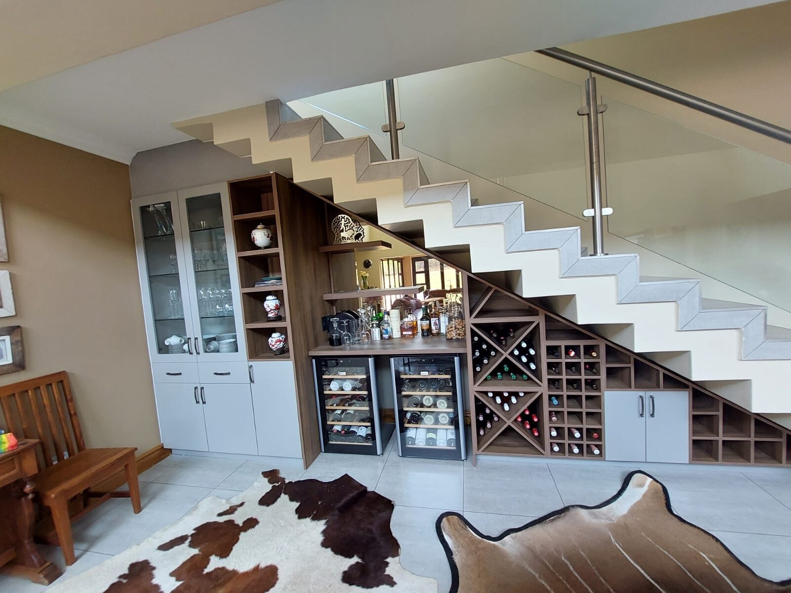 Under-stair wine cellar and bar with X-frame racks