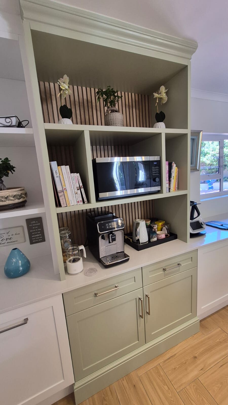Sage green built-in coffee station with open shelving
