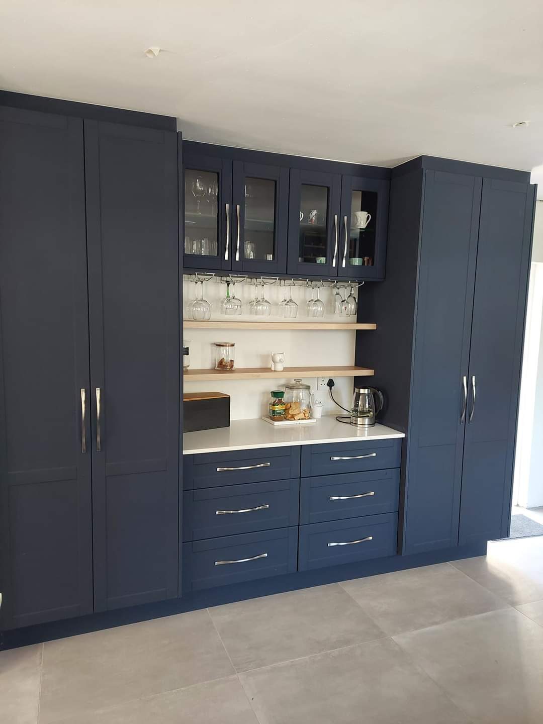 Navy floor-to-ceiling wardrobe and display hutch
