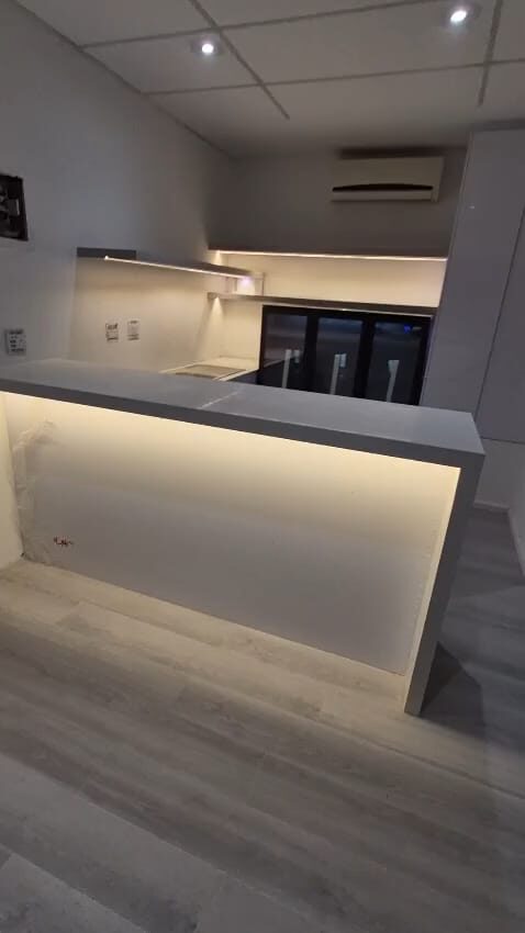 Walk-in dressing room with black-framed glass wardrobe doors
