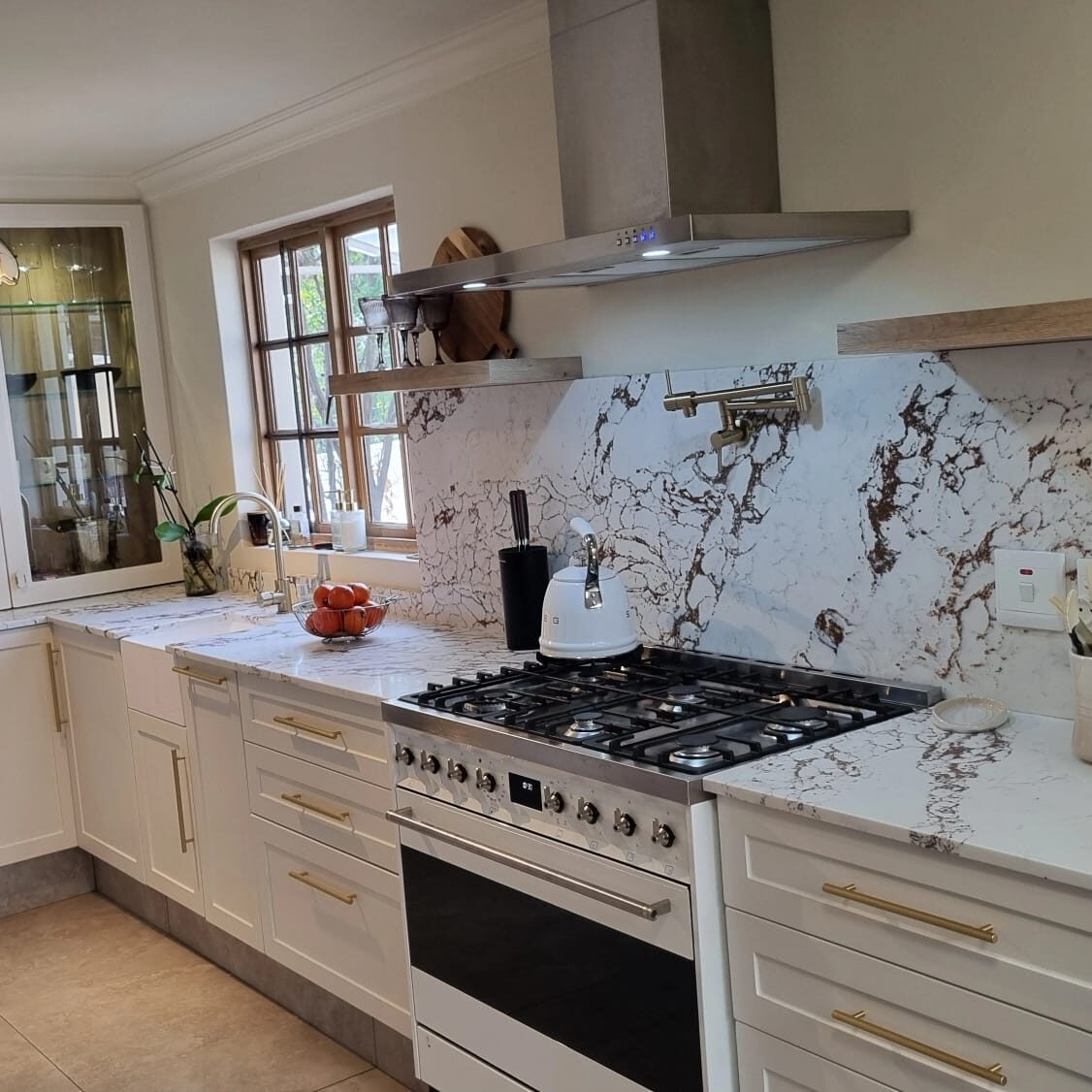 Bespoke white marble waterfall-edge kitchen island by Signature Kitchens