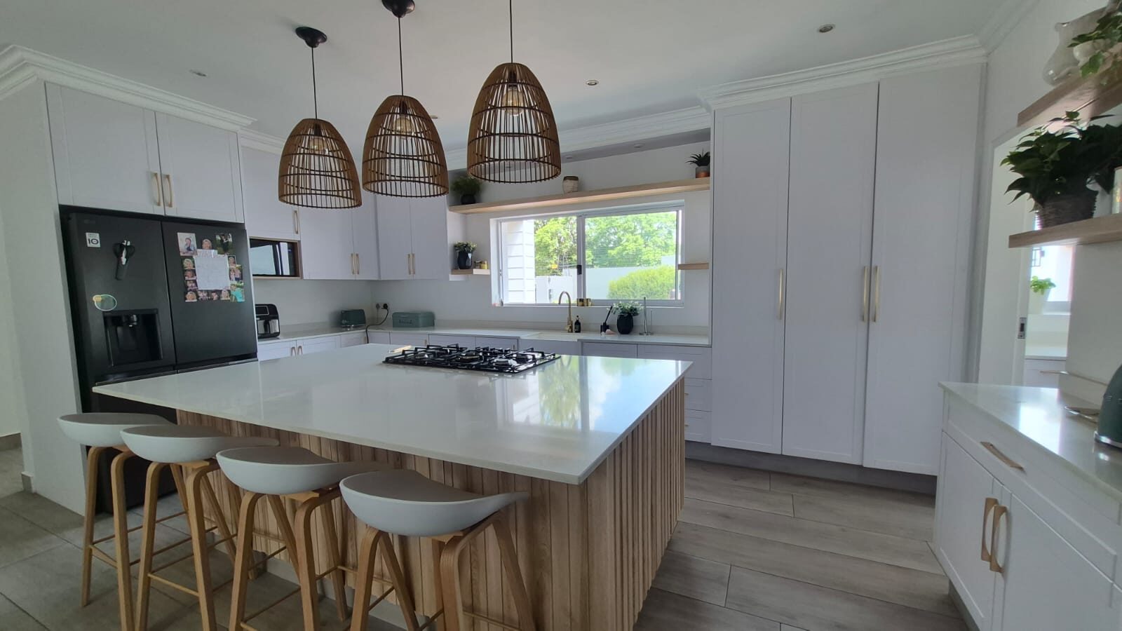 White kitchen with rattan pendant lights