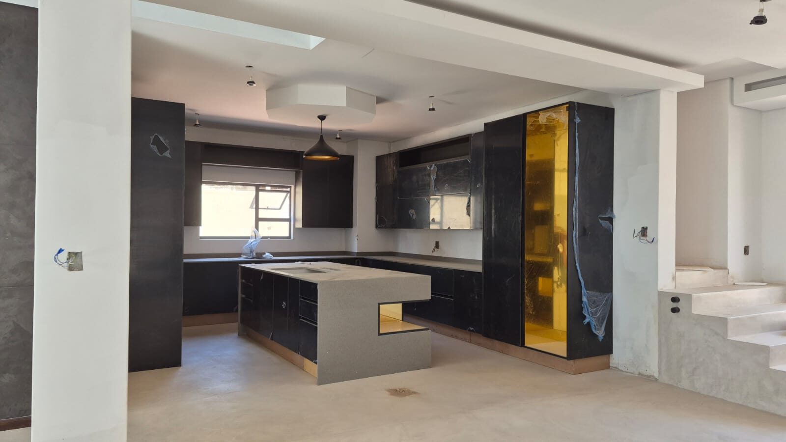 White marble waterfall island kitchen with wine fridge