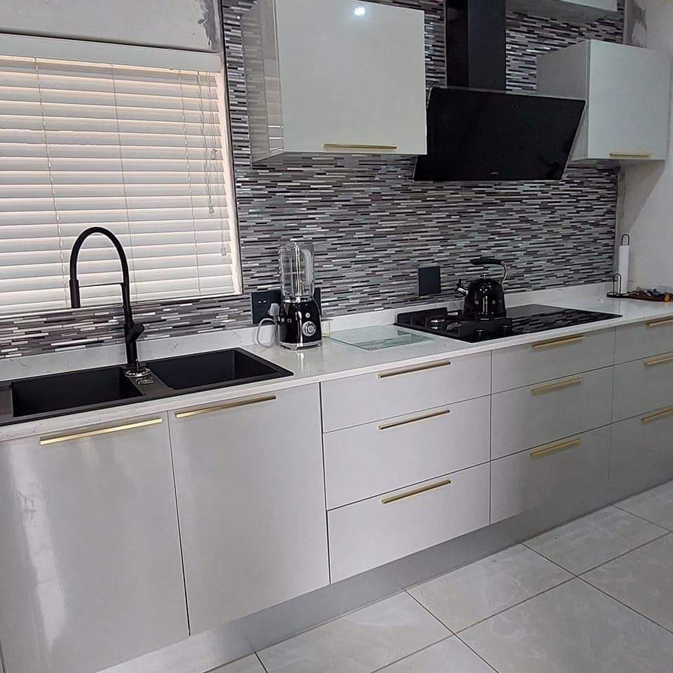 Modern grey gloss kitchen with mosaic tile splashback