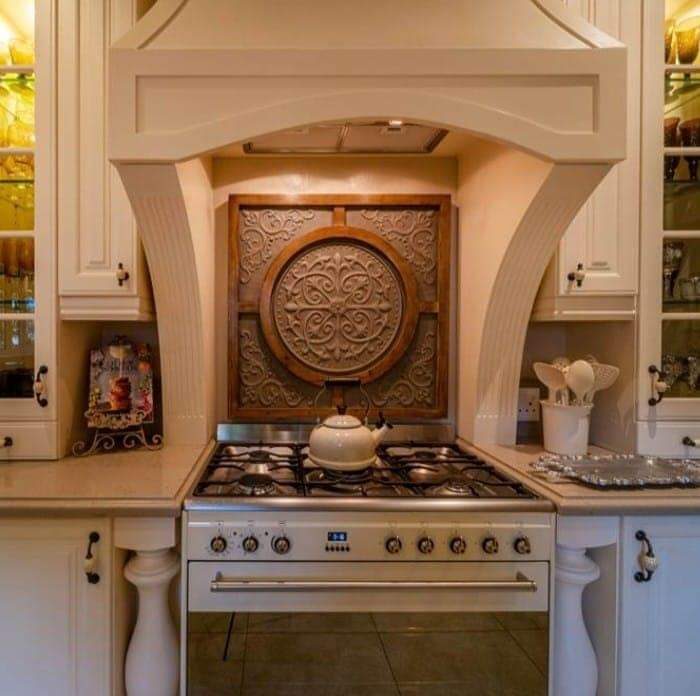 Classic cream kitchen with carved wood feature panel