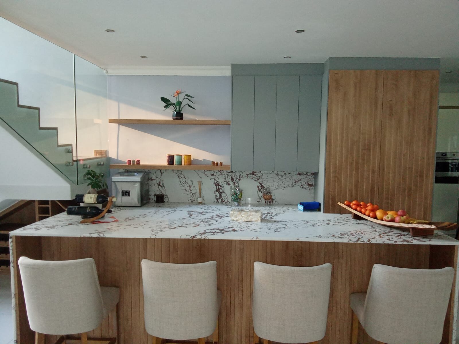 Sage green and oak kitchen with waterfall marble island