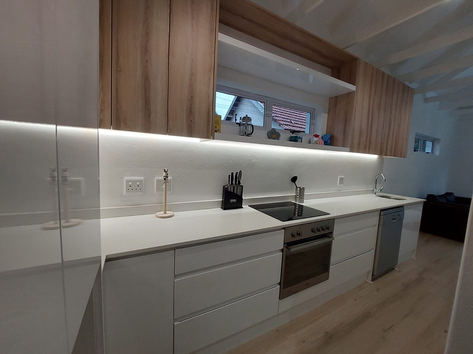 Glossy white minimalist galley kitchen