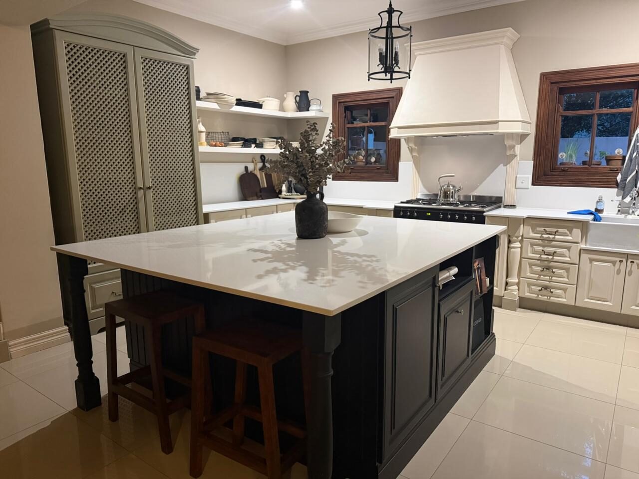 Classic kitchen with dark island and wall clock feature